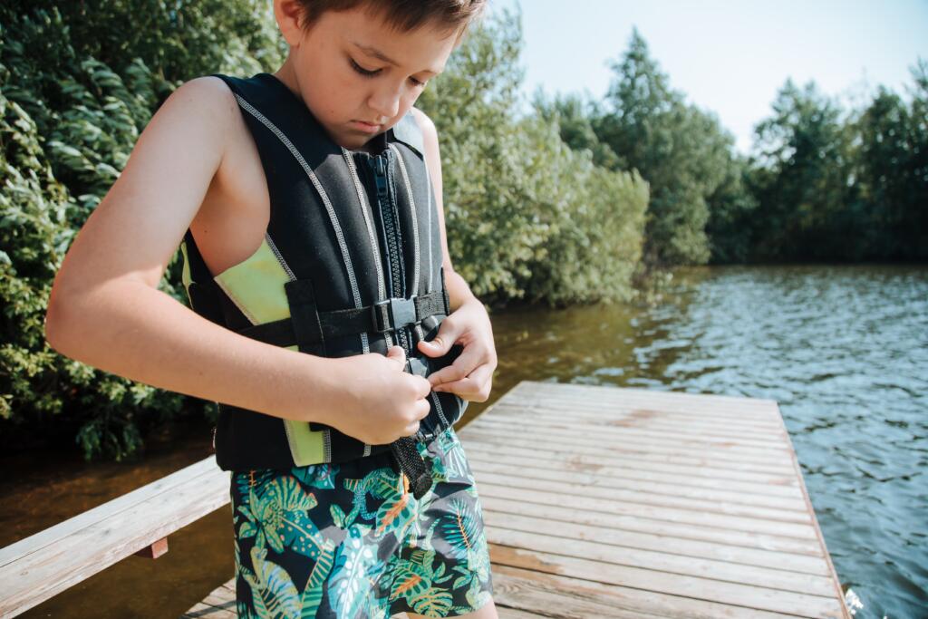 Kid inspecting life jacket