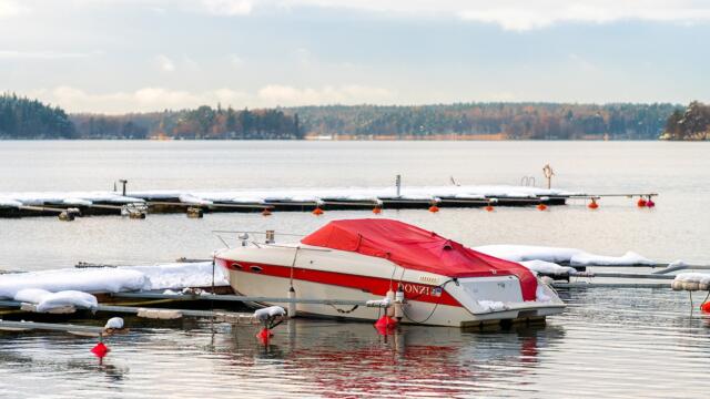 boat docked with cold weather cover on it