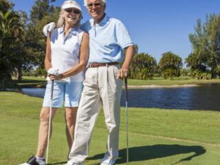 retired couple golfing on lake