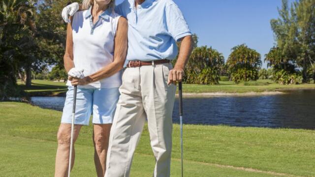 retired couple golfing on lake