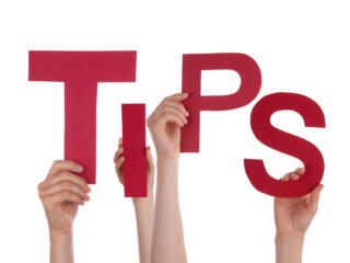 hands holding up letters that spell "tips"