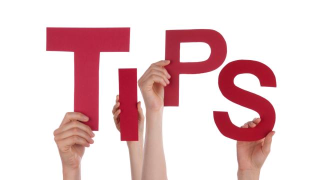 hands holding up letters that spell "tips"