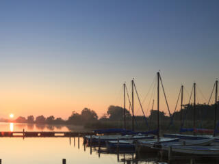 Sailboats docked at sunset