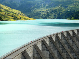 aerial view of dam and the water it is holding back