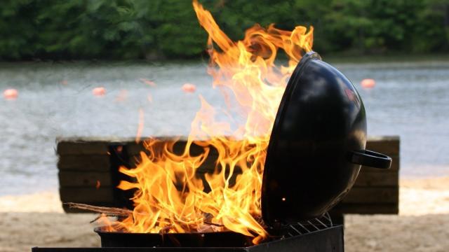 flaming grill on lakeside beach