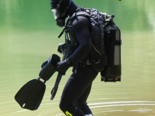 scuba diving in gear standing in the water