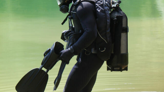 scuba diving in gear standing in the water