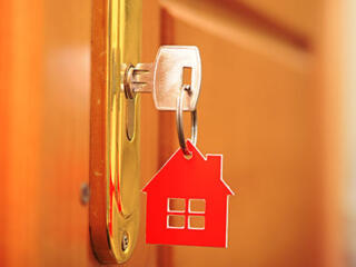 key in door lock with house keychain