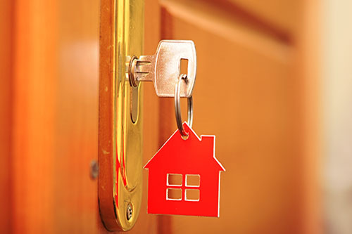 key in door lock with house keychain