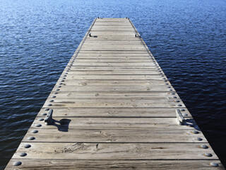 wooden boat dock/pier extending out into open water