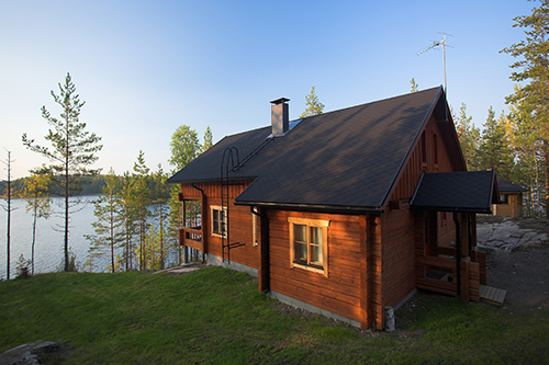 brown house overlooking lake