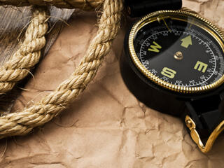 compass and rope over brown butcher paper