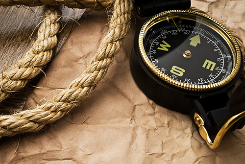 compass and rope over brown butcher paper