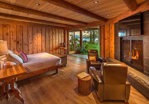 Hardwood flooring of lake house with fireplace and walk out patio