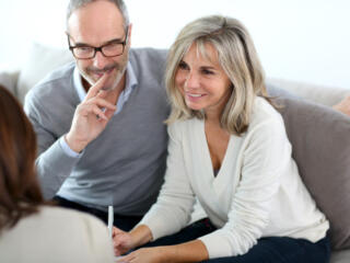 Couple sitting on sofa considering relisting