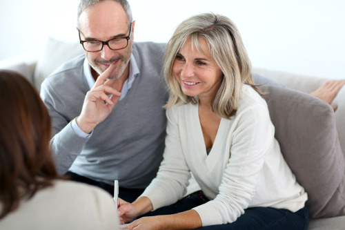 Couple sitting on sofa considering relisting