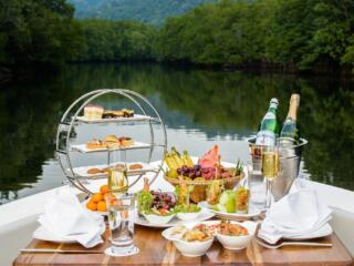 food on the bow of boat overlooking the lake