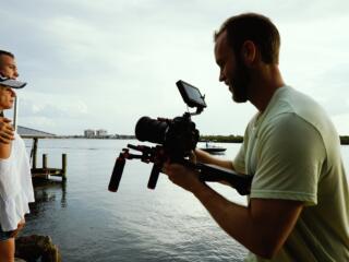 cinematographer filming a lake movie