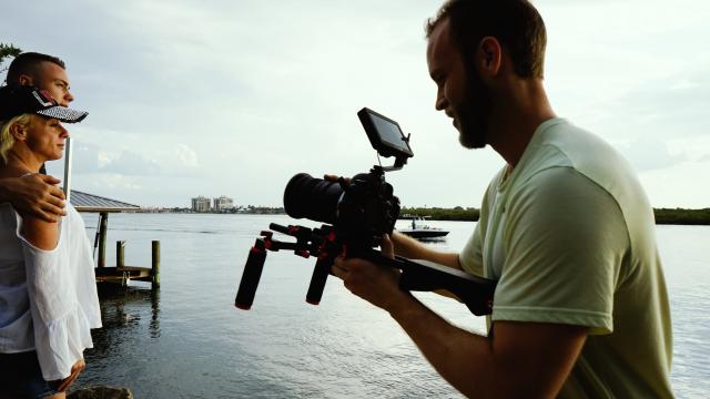 cinematographer filming a lake movie