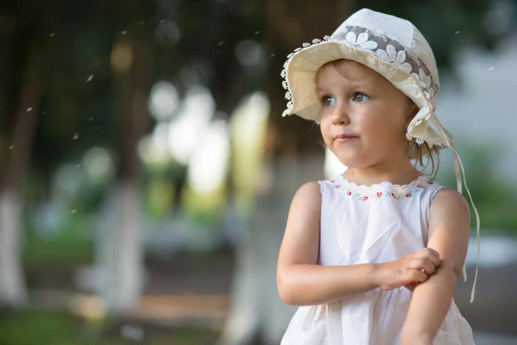 Bug spray Young child near flying insects