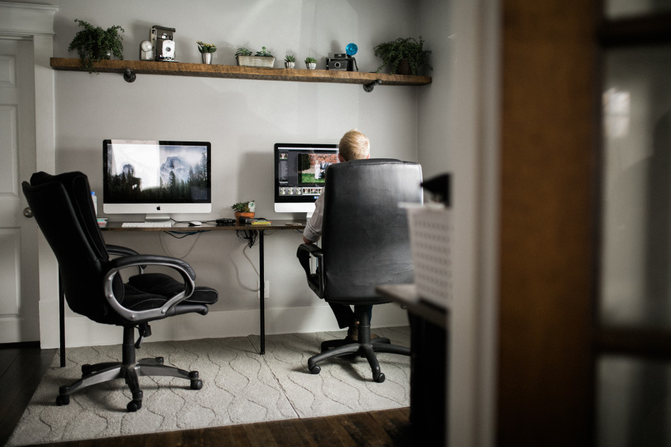 business center for travelers man using mac computer