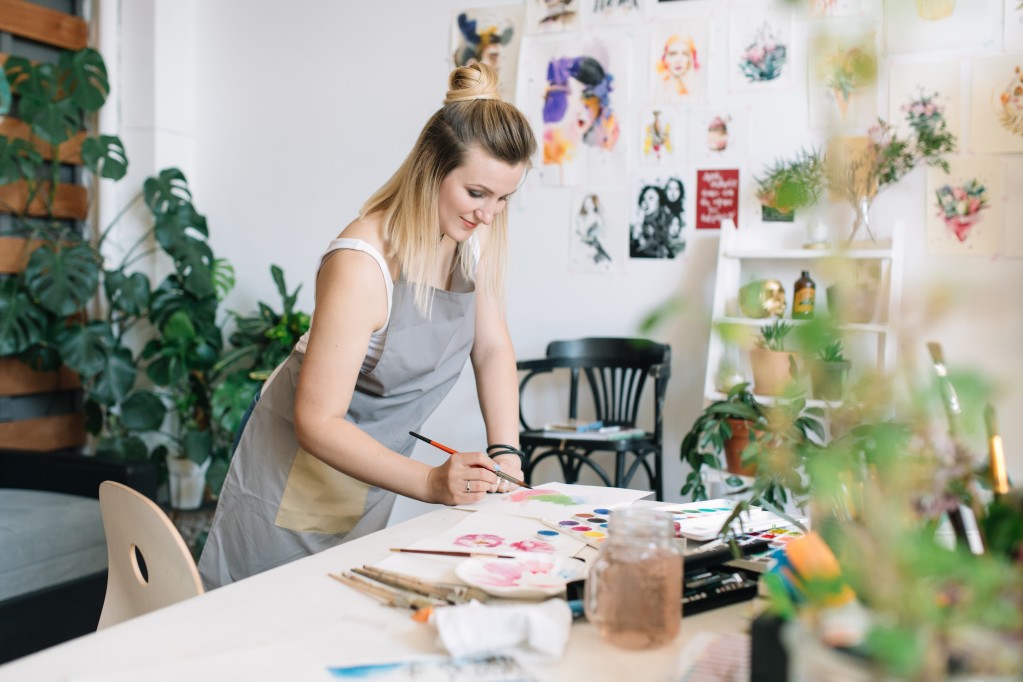 woman painting in art production studio