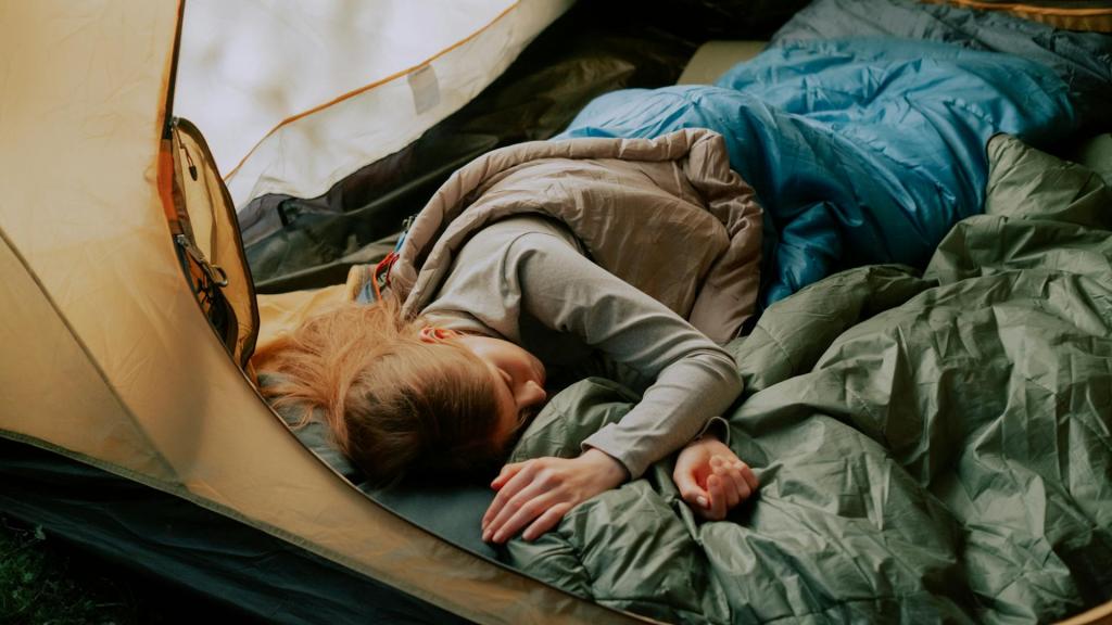 woman sleeping in a sleeping bag in a tent