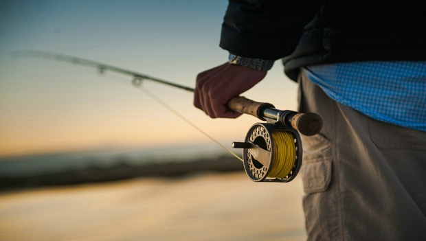 Man-Holding-Fly-Rod-Carousel-active