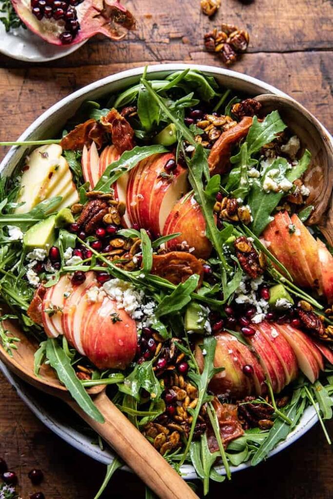 Autumn harvest salad with pomegranates, apples, pecans, pumpkin seeds, and prosciutto.