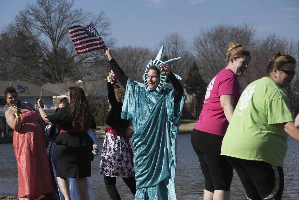 People getting ready to jump in the cold St. Louis lake to support Special Olympics Missouri, including a girl dressed up like the Statue of Liberty.