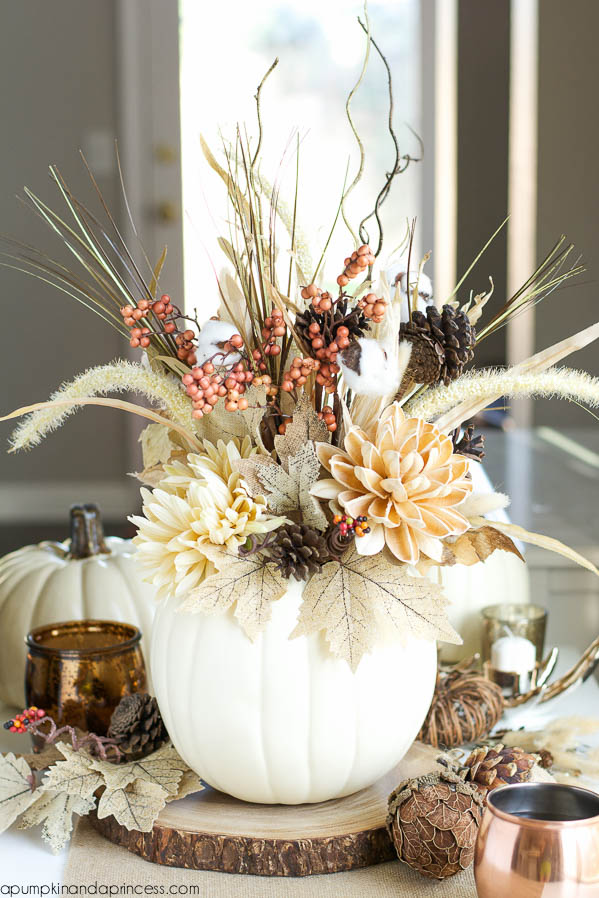 DIY pumpkin centerpiece, made from pine cones and a variety of fall stems.