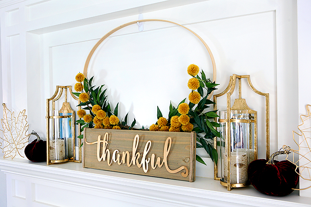 DIY Thanksgiving centerpiece with fall stems and a sign that reads "thankful."