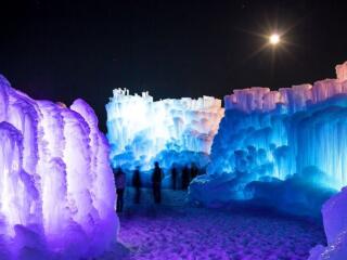 Ice Castles lit by blue and purple lights