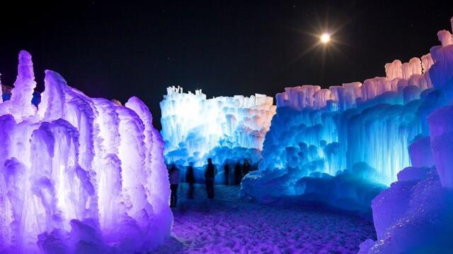 Ice Castles lit by blue and purple lights