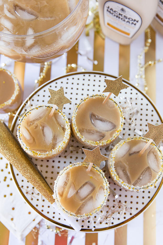 New Year's Eve cocktails on a festive plate with glittery sugar around the rims. 