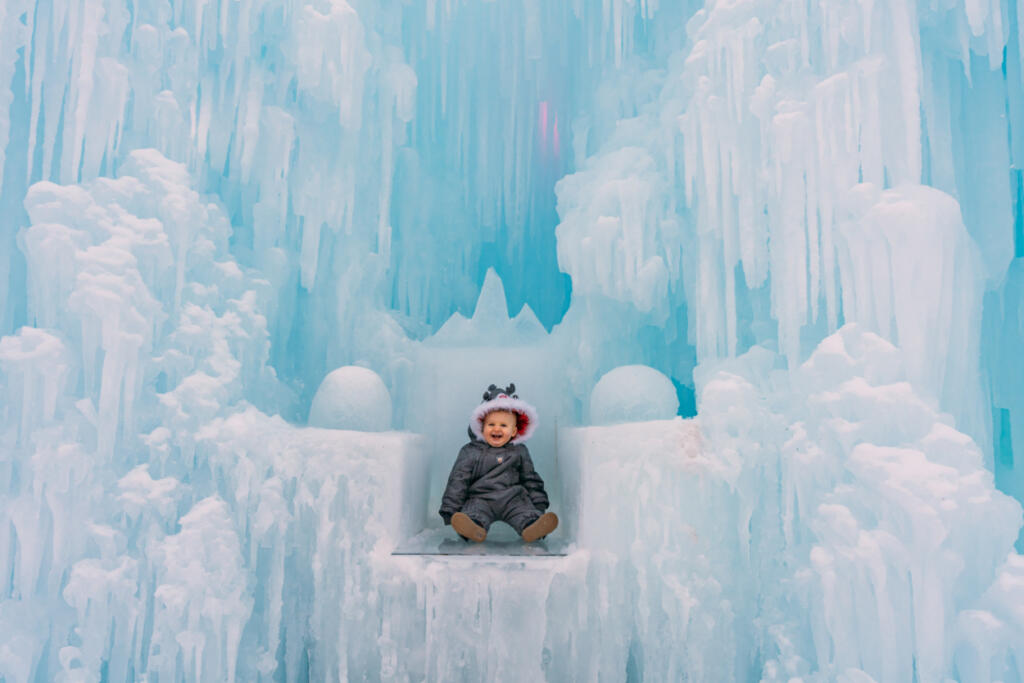Child in front of a frozen winter display.