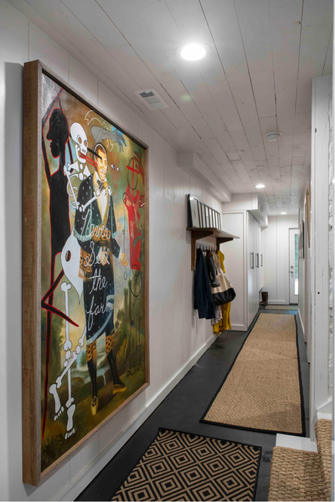 downstairs hallway with colorful artwork by Butch Anthony