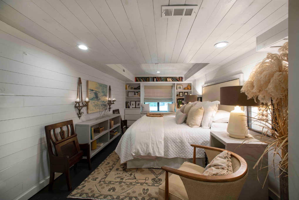 downstairs guest room with all-white palette and built-in shelves