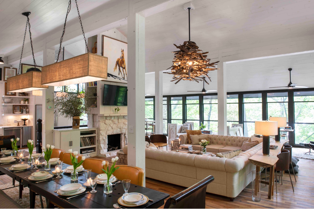 View of dining room, living room, and fireplace in reclaimed family cabin