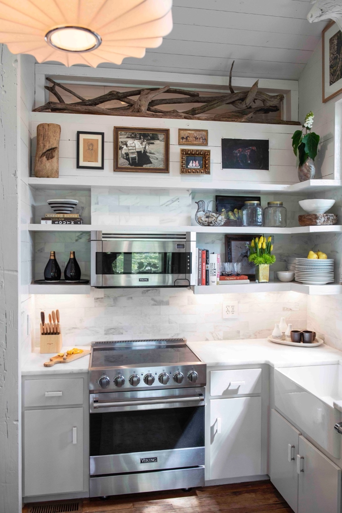 kitchen with open shelving displaying family collectibles and artwork