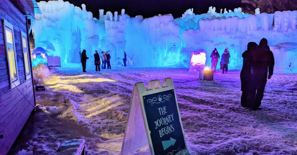 Sign that says the journey begins in front of an ice castle.