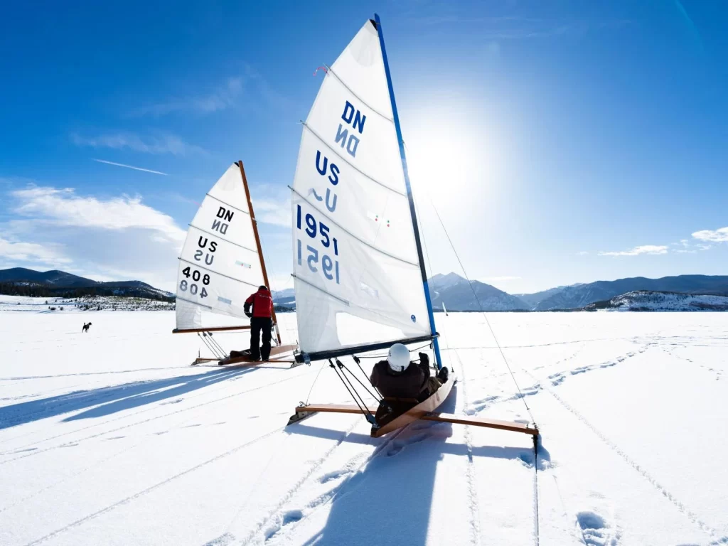 Two ice boats sailing across the snow