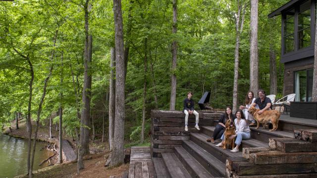 Billy Reid and family with dog on steps in front of Wilson Lake, Alabama