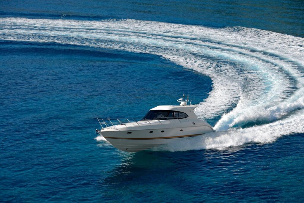 a yacht moving through the water creating a wake