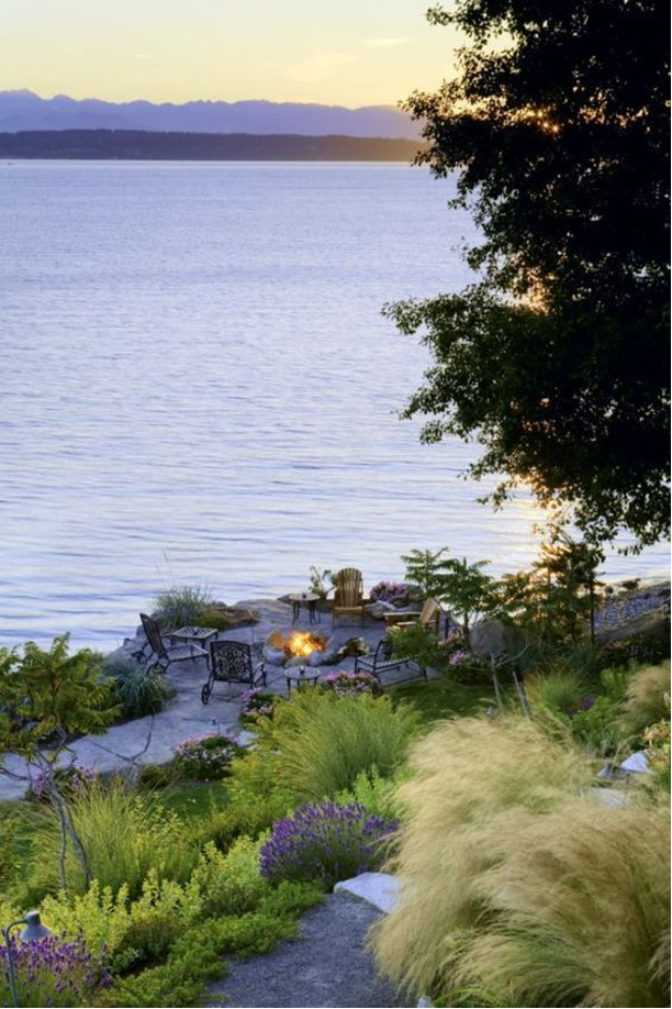 ornamental grasses on lake landscape with seating area and fire pit
