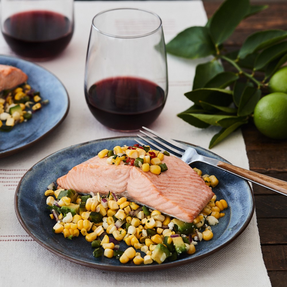Pan-seared salmon with corn and pablano salad served with pinot noir