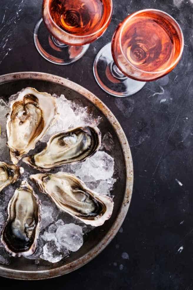 raw oysters on the half shell with rose wine