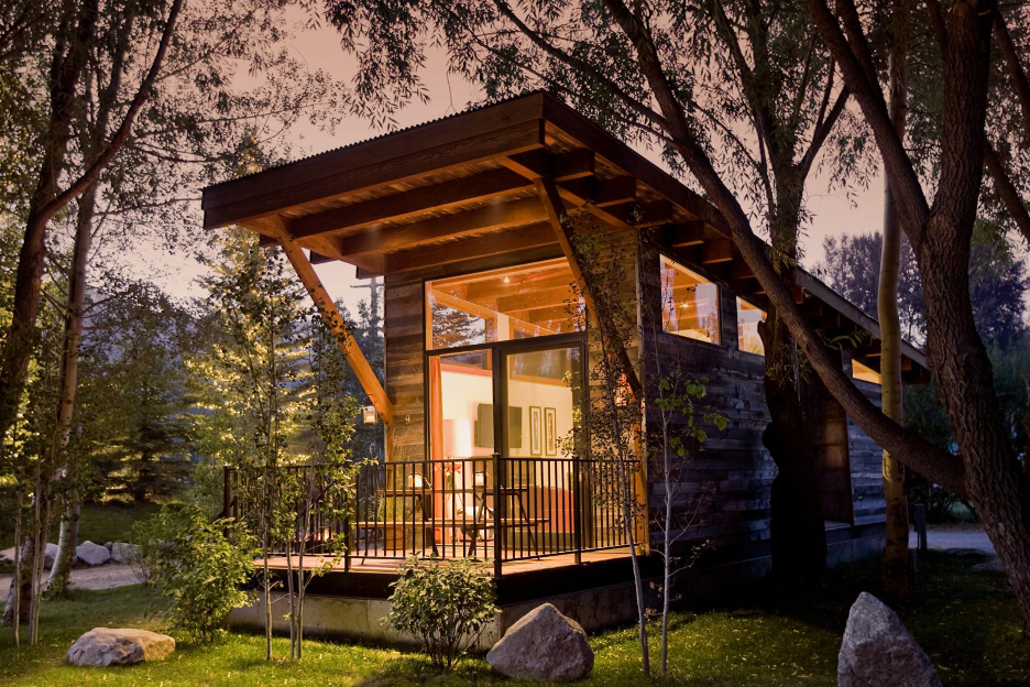 Covered outdoor space with railing at lake home