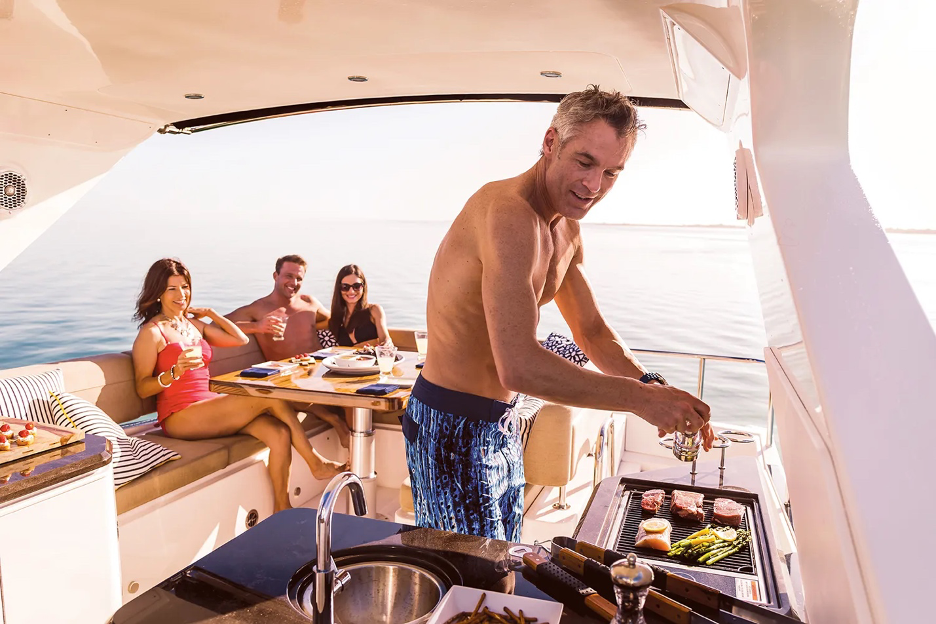 people grilling on a boat on the lake