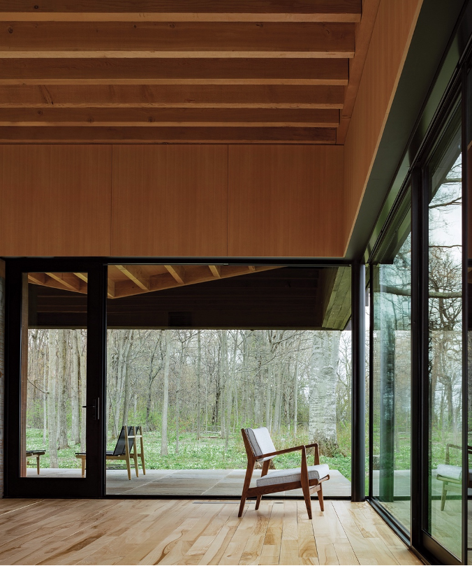 living area showing ceiling beams and woodland views outside